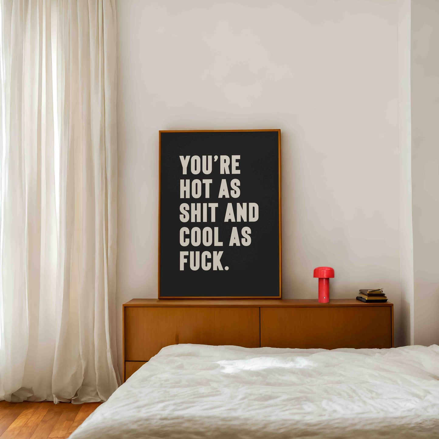 Bold black and white typography print that reads “You’re hot as shit and cool as f*ck,” styled in a modern bedroom setting. A cheeky, empowering quote print ideal for renters, couples, or anyone who loves bold graphic art.