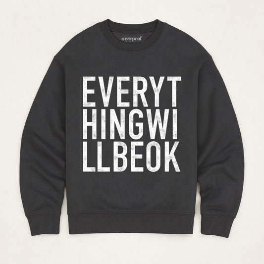 Black oversized, organic unisex sweatshirt with bold vintage style typography in white saying "Everything will be ok"  Photographed  as a flay lay on a plain background. 