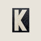 Letter K oil paint texture typography print on off white background
