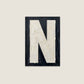 Letter N oil paint texture typography print on off white background