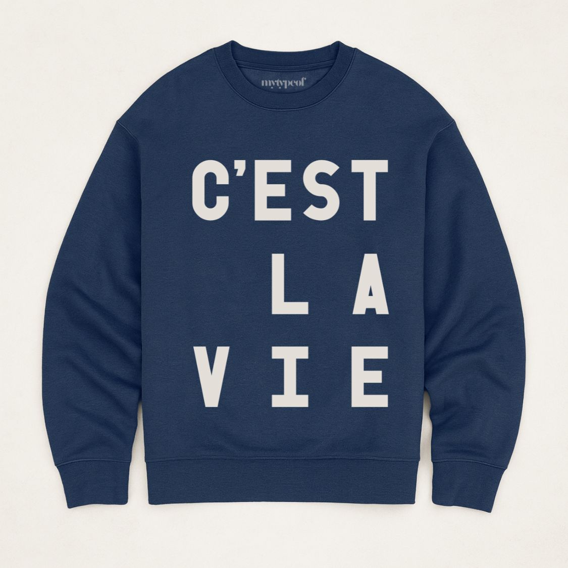 Navy blue colour typographic sweatshirt, with 'C'est La Vie' design. unisex, oversized sweatshirt, photographed  as a flay lay on a plain background. 