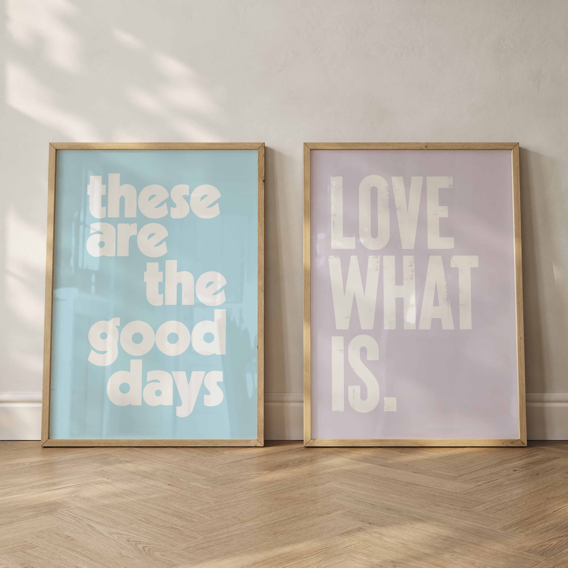 2 framed prints in pastel colours and Pantones colour of the year Cloud Dancer. One says"these are the good days" the other "Love What Is"
