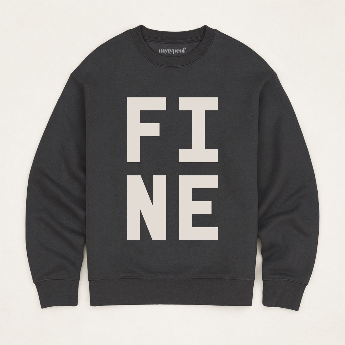 Black bold typographic designed sweatshirt, with 'FINE' design. Unisex, oversized sweatshirt, photographed  as a flay lay on a plain background. 