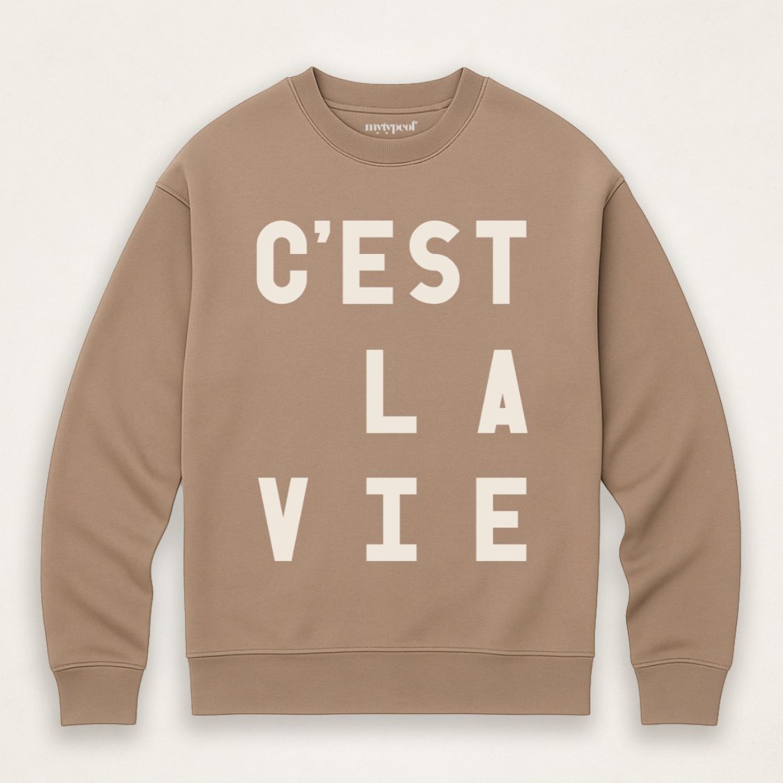 Driftwood, caramel colour typographic sweatshirt, with 'C'est La Vie' design. unisex, oversized sweatshirt, photographed  as a flay lay on a plain background. 