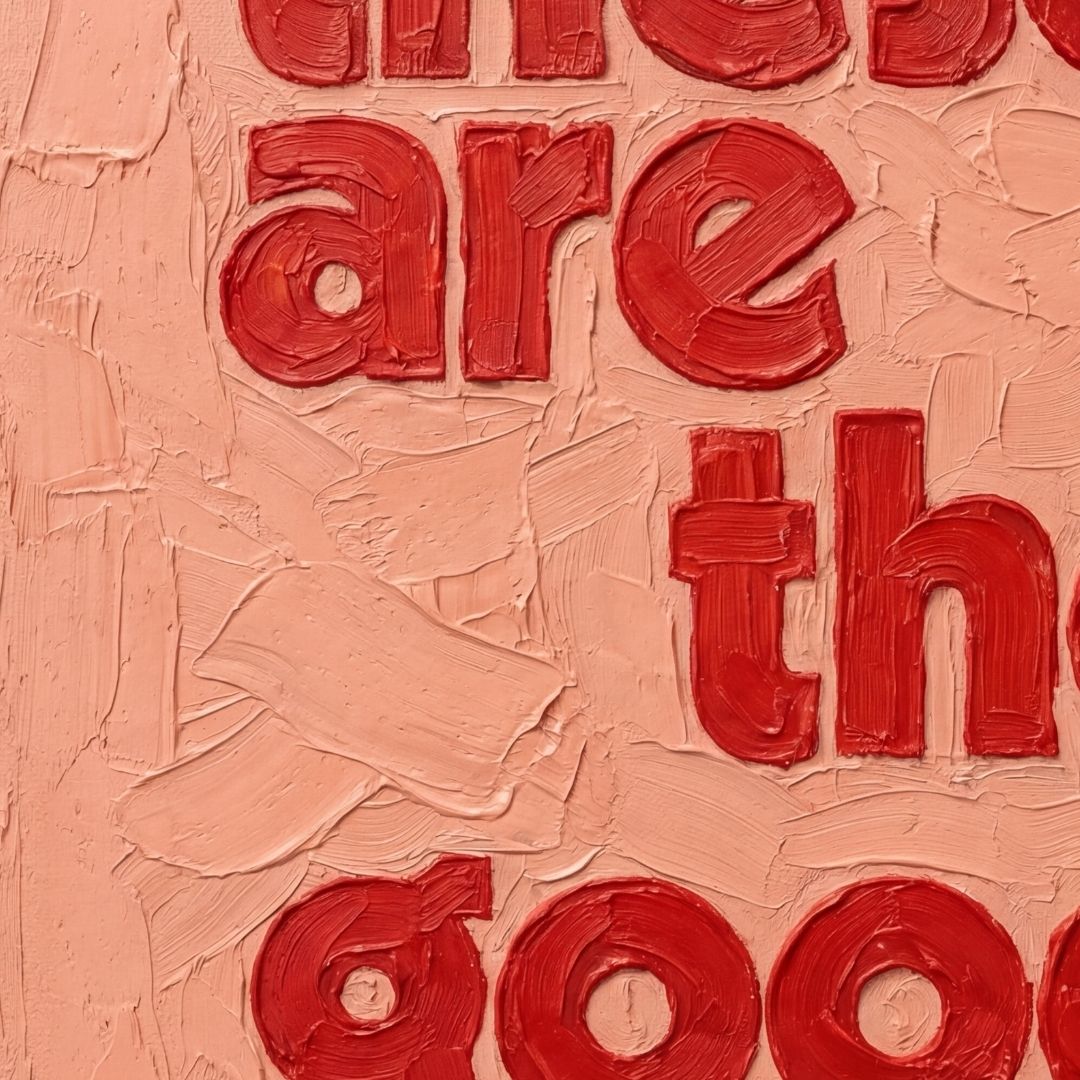 Detail shot of textured quote print showing layered oil paint effect on canvas. pink and red, These are the good days quote. 
