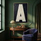 Letter A oil paint art print framed in brass styled on  a gree wall interior with large window