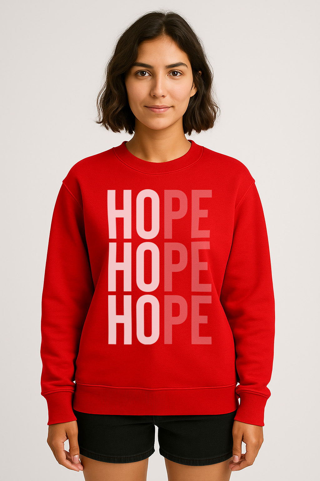 woman wearing a red Hope sweatshirt, with the design also spelling out Ho Ho Ho. 