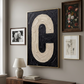 Letter C oil paint art print framed in brass styled on a gallery wall over a sideboard. 