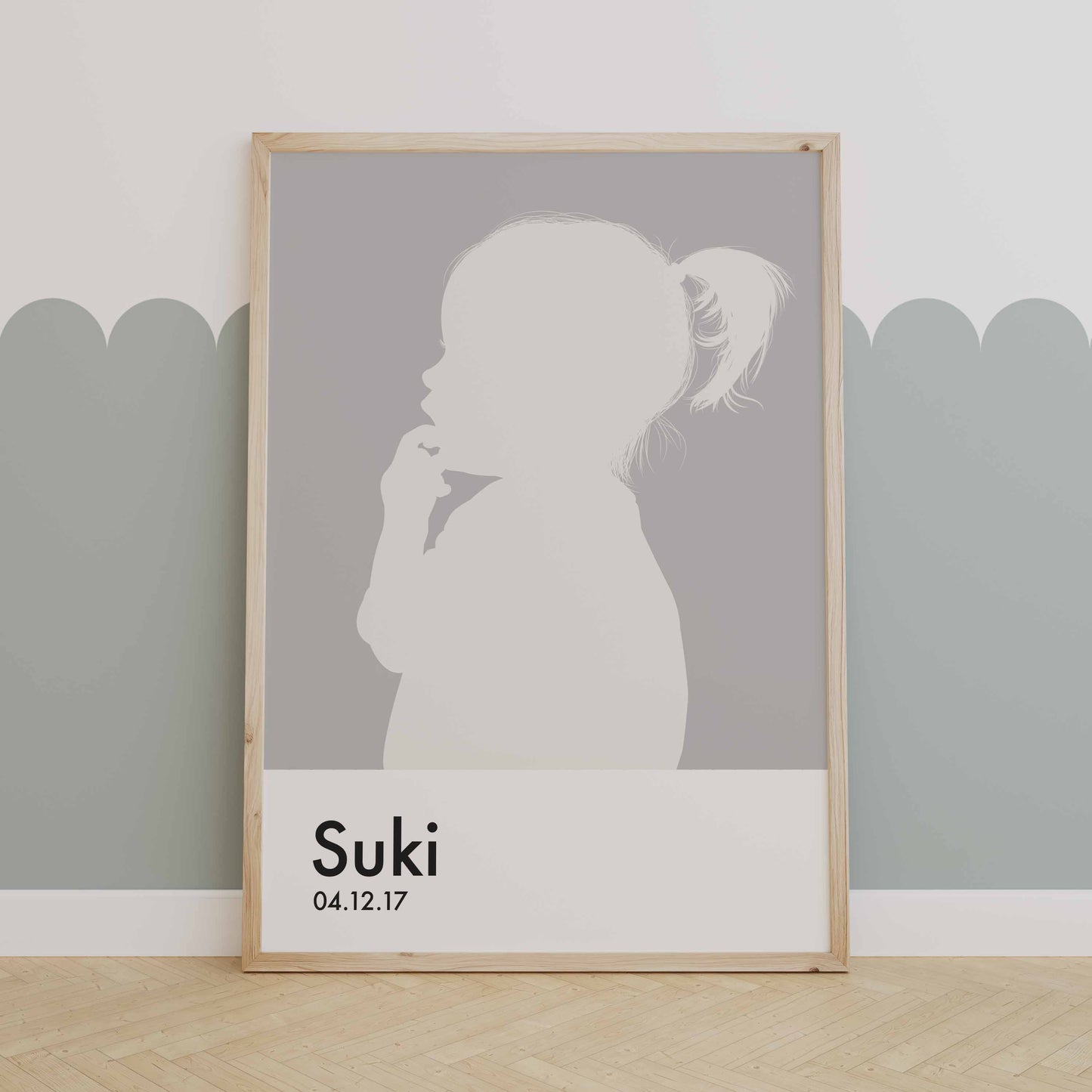 Silhouette portrait of little girl in Pantones colour of the year 2026 cloud dancer, Her name and birthdate are underneath in a Pantone swatch style, framed in a natural wood. 