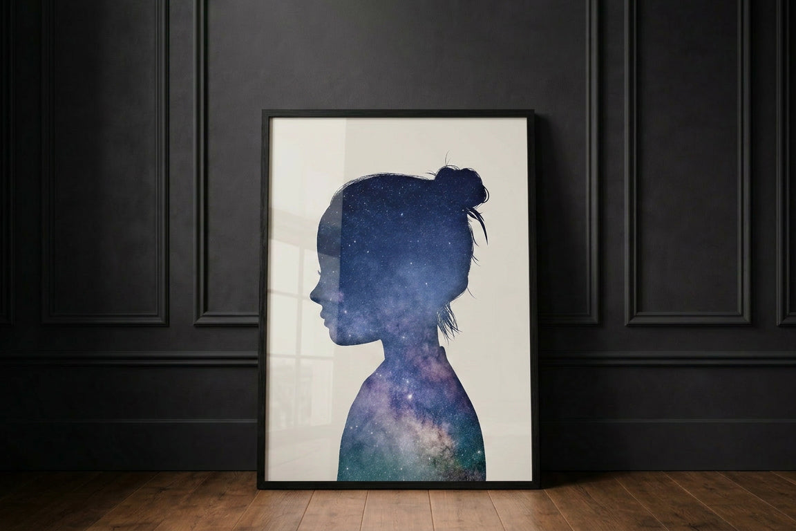 Little peach portrait in the cosmic collection, showing a girl with The Universe filling her side profile silhouette. Framed in black against a black wall. 