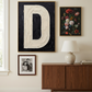 Letter D oil paint art print framed in brass styled on   a mid century sideboard interior with large window