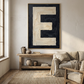Letter E oil paint art print framed in oak frame styled in a rustic interiror with sofa and large window i