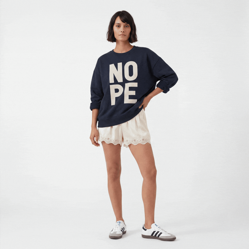 Eve wearing the NOPE premium organic sweatshirt styled with different bottoms and accessories, showing how it works with everything from leopard shorts to denim to joggers.