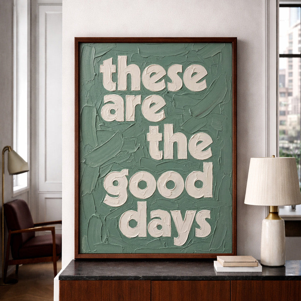 Quote print in dusky green colour, finished in a textured oil paint style, These are the good days quote print, framed in a NY apartment. 