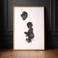Modern ink silhouette personalised portrait of girl and a balloon. Framed, and leaning against a black panelled wall. 