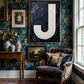 Letter J oil paint art print framed in brass styled in a maximalist interior with large window