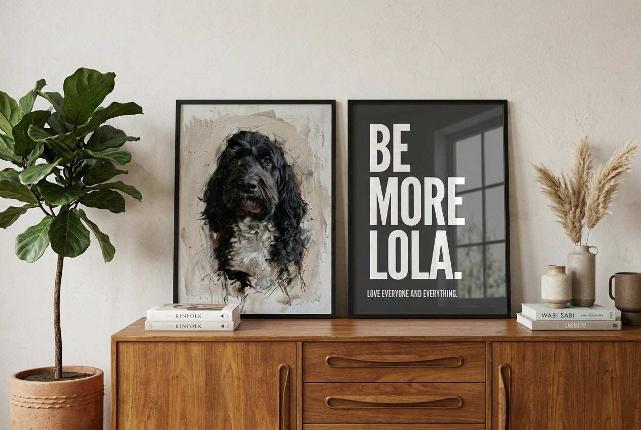 Custom pet portrait and personalised dog name print displayed in black frames on a wooden sideboard, styled with neutral home accessories and a fiddle leaf fig plant.