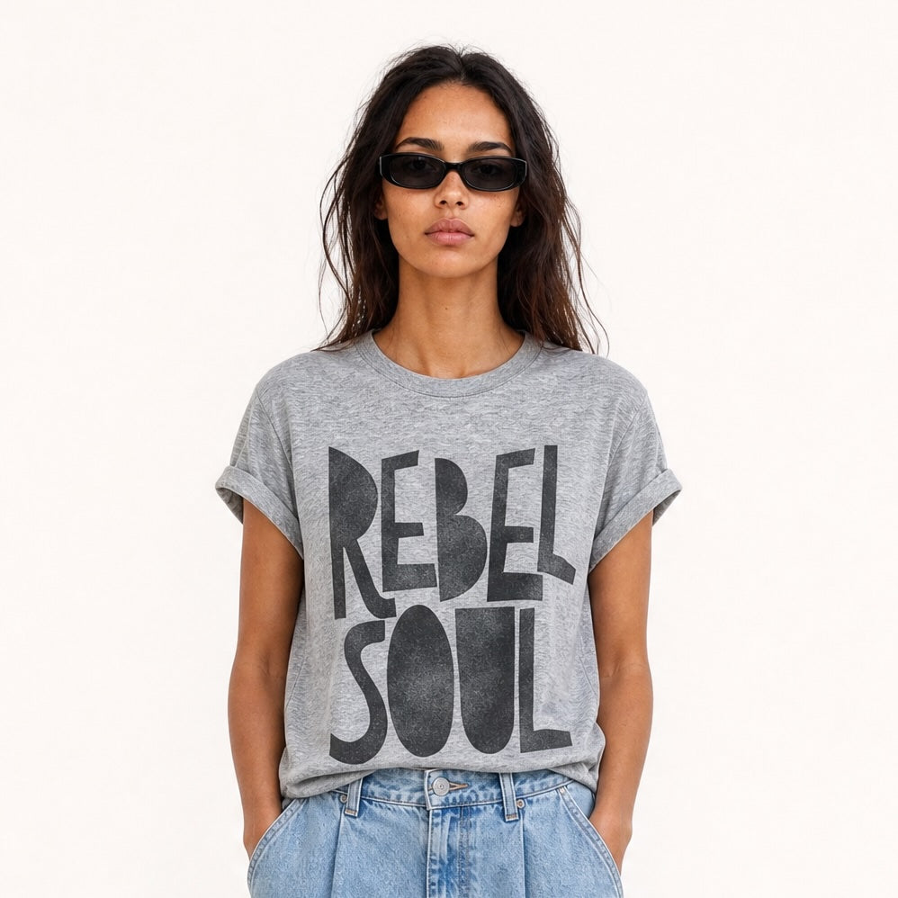 Woman wearing an oversized grey Rebel Soul graphic T-shirt with bold black typography,