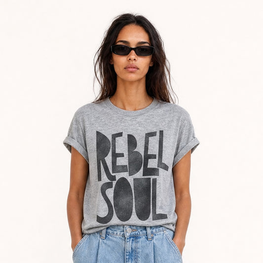 Woman wearing an oversized grey Rebel Soul graphic T-shirt with bold black typography,