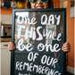 Little girl with sunglasses holding a framed black and white custom made quote print of her quote: One days this will be one of our rememberings