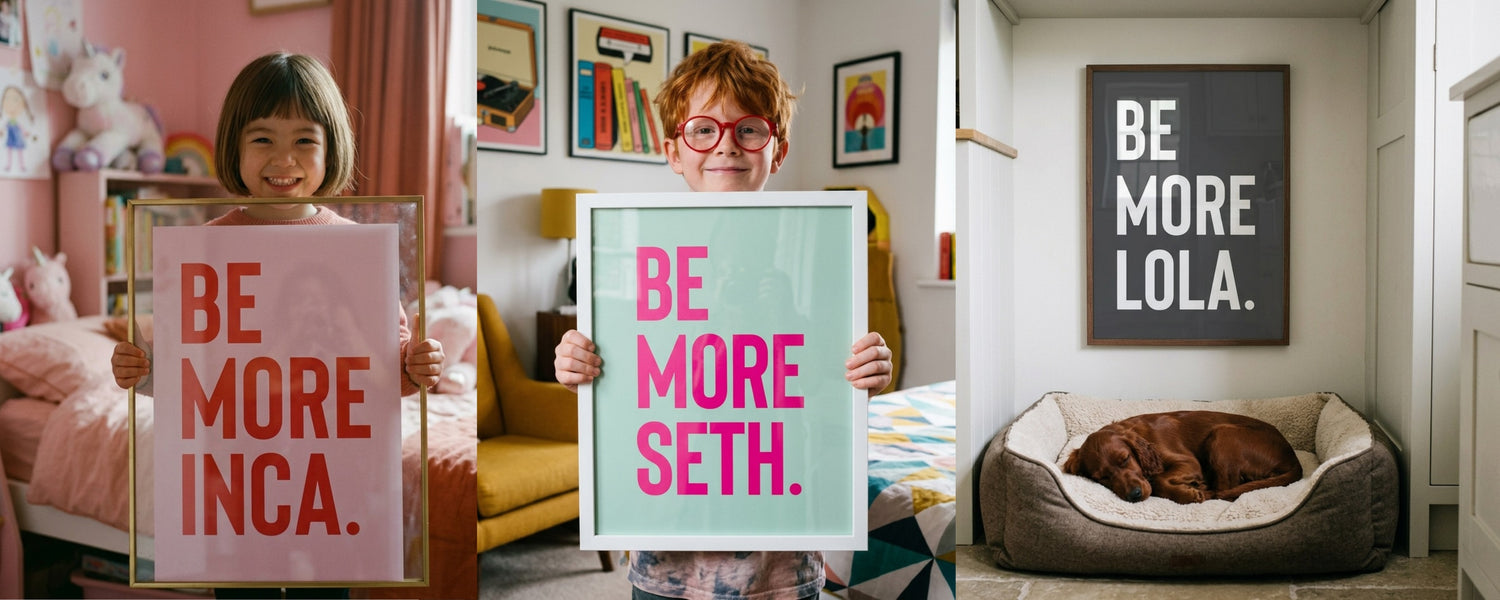 Three children holding personalised "Be More [Name]" bold typography art prints in their bedrooms, with a framed "Be More Lola" print displayed on a child's bedroom wall above a sleeping dog.