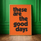 Bright orange bold typographic quote print framed against a green wall. "these are the good days" positive uplifting quote for modern colourful 
interiors. 