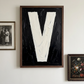 Letter V oil paint art print framed in a wood, on a white wall with 2 other prints and natural shadows. 