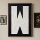 Letter W oil paint art print framed in a wooden frame, in a gallery wall on white wall. 